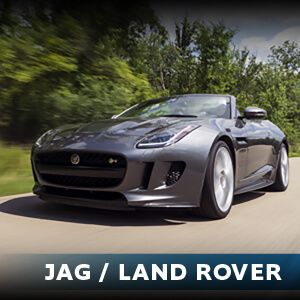 A jaguar land rover is driving down a road