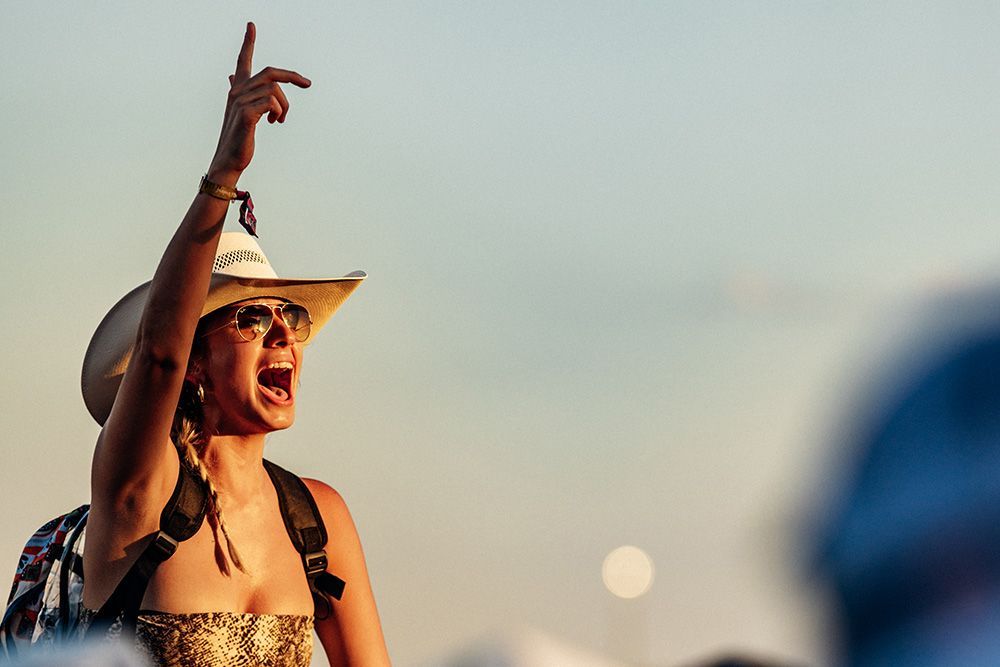 Woman cheering at outdoor music festival