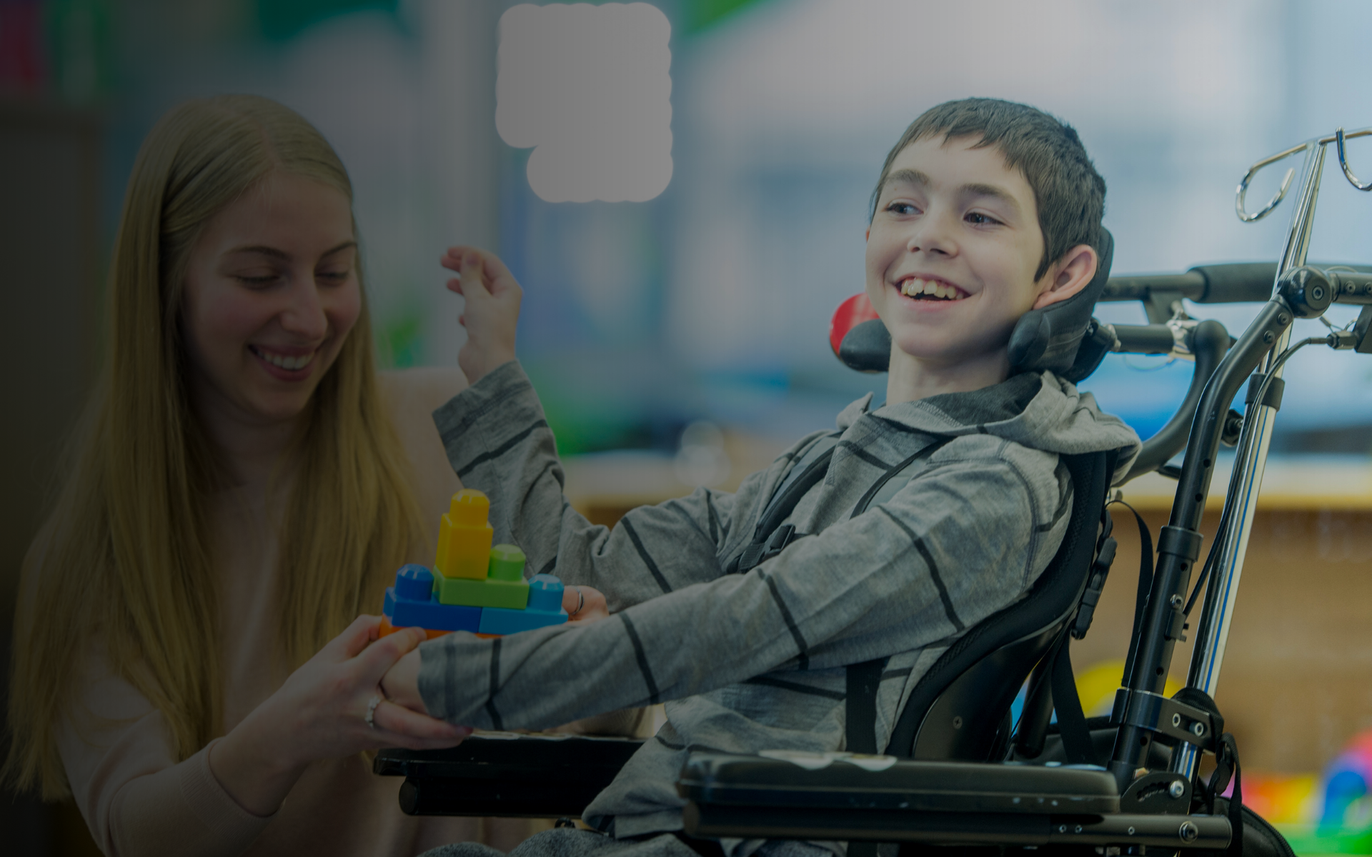 Child with cerebral palsy smiling during therapy activity with motor impairment and supportive care.