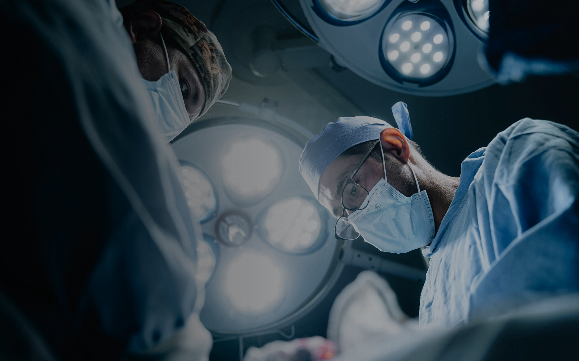 doctors hovering over operating table