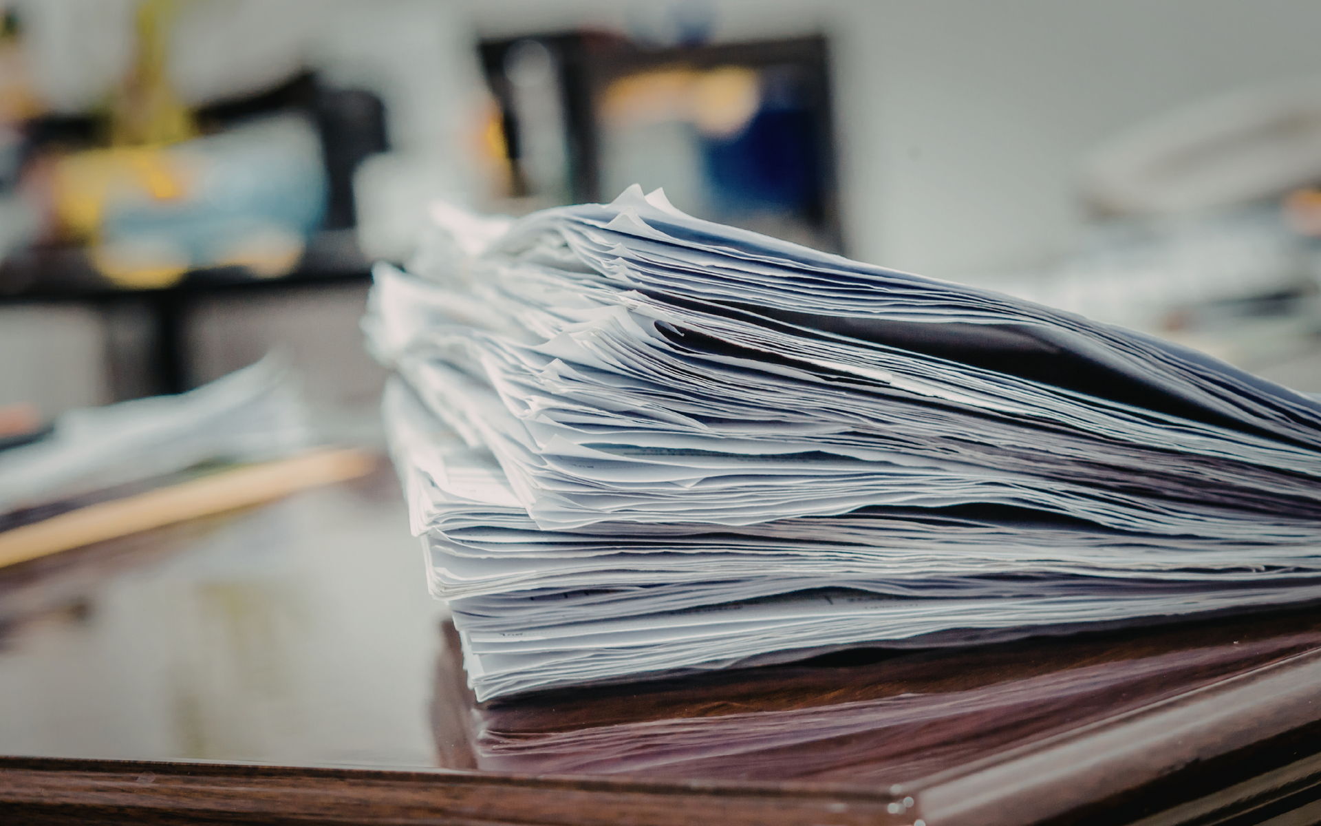 Stack of papers representing False Claims Act risk, audits, and recoupments