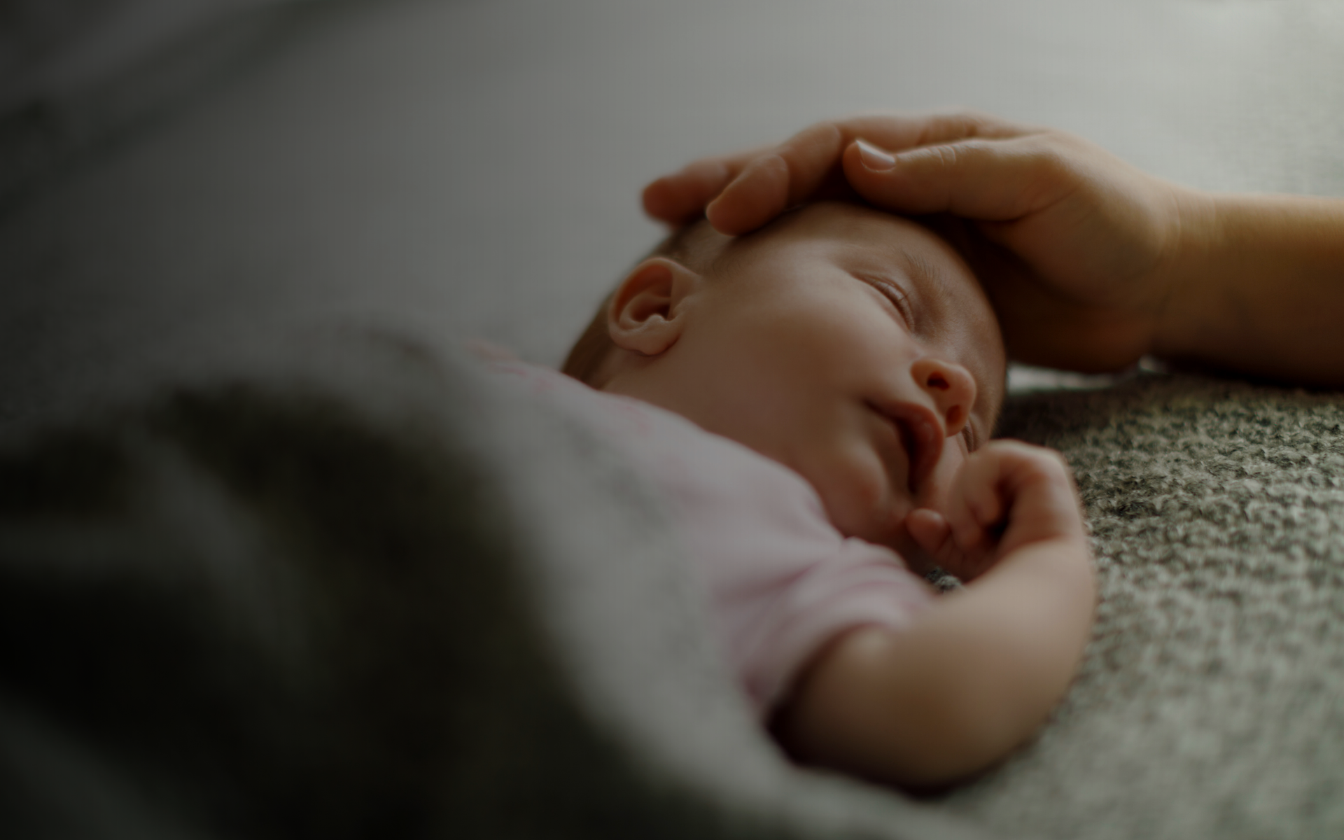 Infant resting after feeding with caregiver support, associated with Sandifer syndrome.
