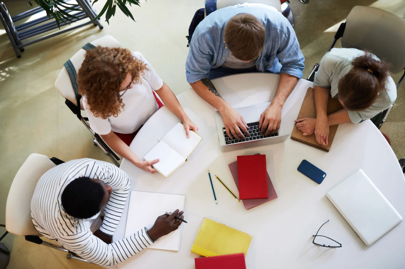 A group of doctors are sitting in chairs listening to a presentation.