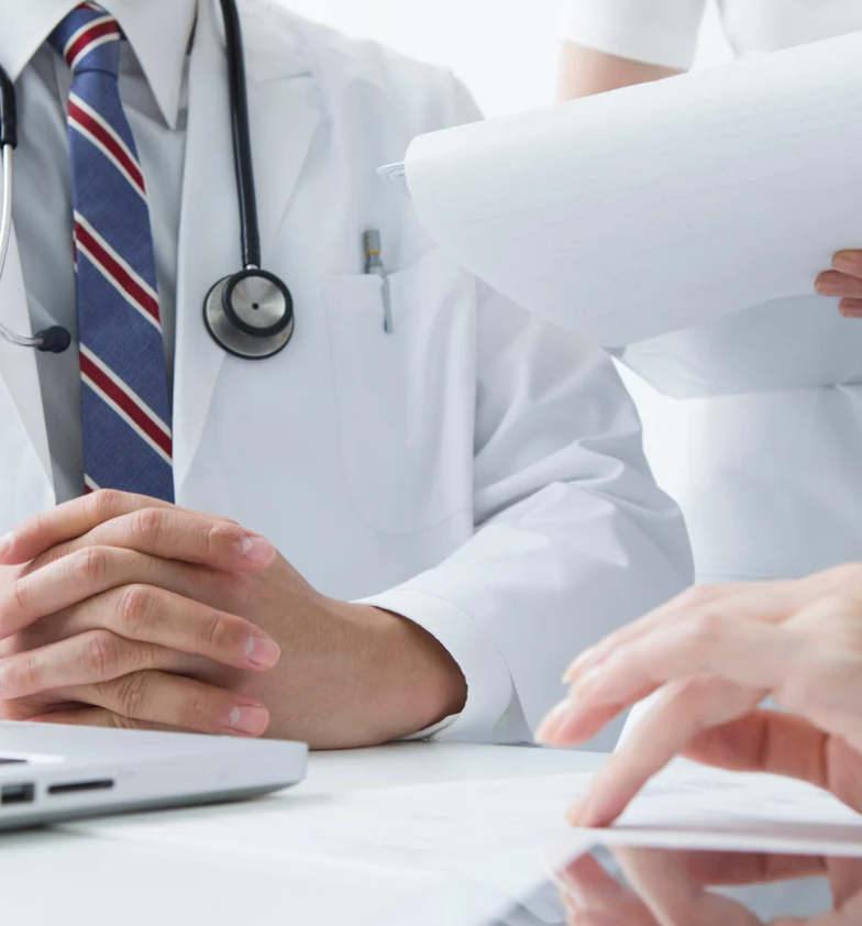 doctor sitting at desk with patient
