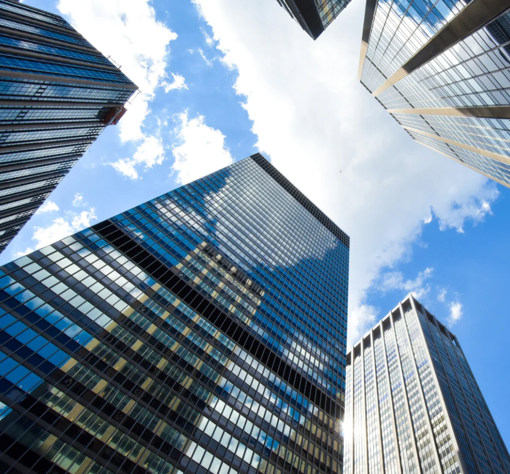 Looking up at a city skyline with a sign that says ' time square ' on it