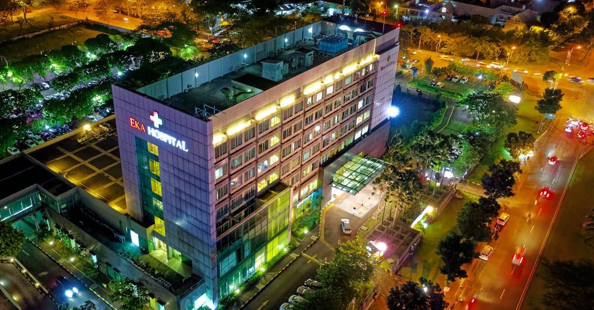 An aerial view of a large building lit up at night.