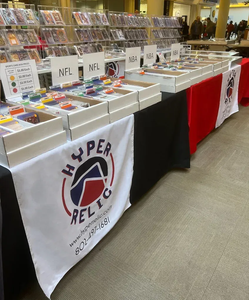 A vendor table with sports cards for sale, labeled