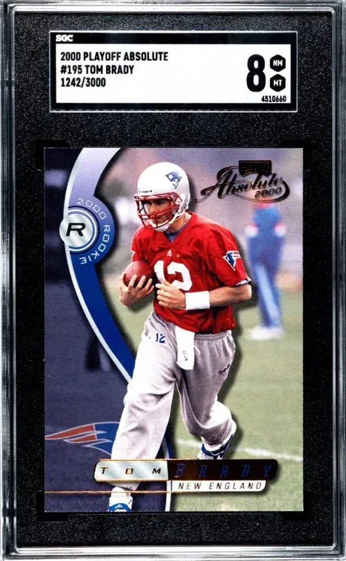Tom Brady rookie football card, graded 8.5, in a black case. Brady in Patriots uniform, running.
