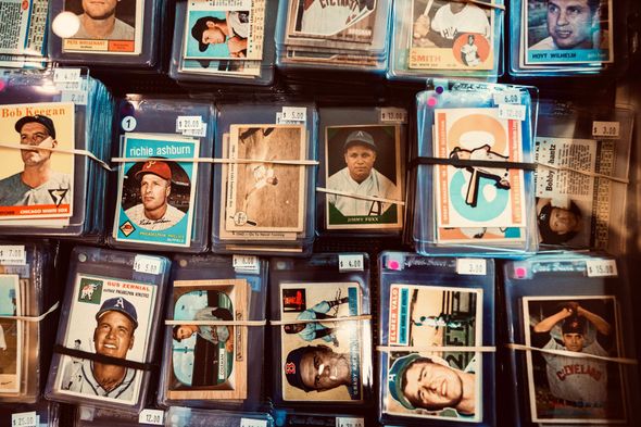 Baseball cards in protective sleeves, bundled with rubber bands.