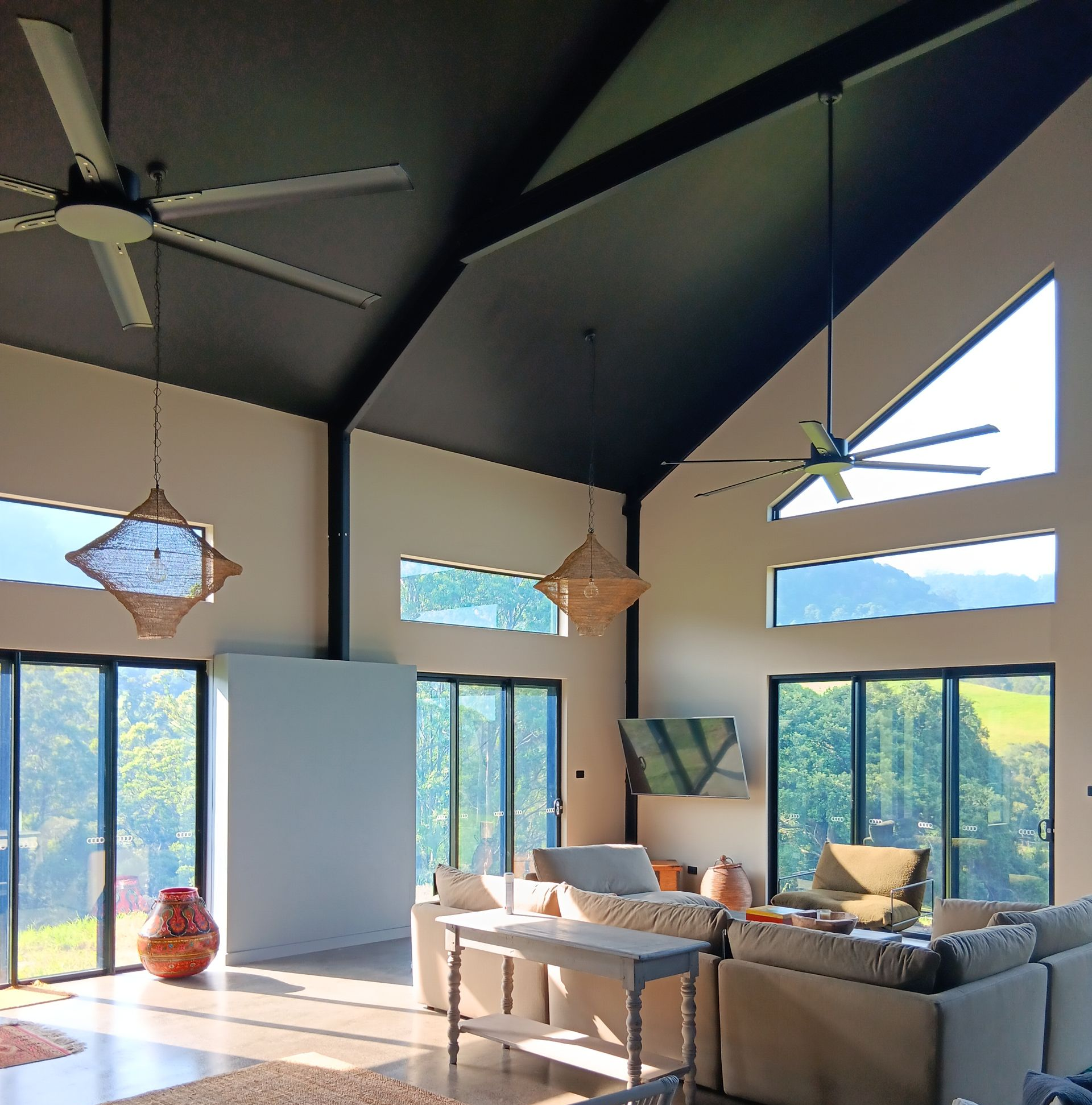 Spacious living room with high ceilings, large windows, and an outdoor view. Features light-coloured walls and a dark ceiling — AMAC Painting & Maintenance Nowra In Nowra, NSW