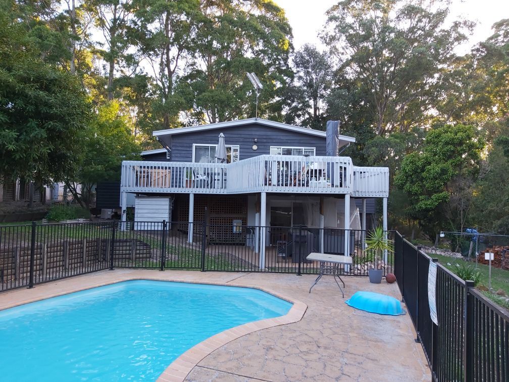 Two-story Grey House With White Balconies and a Pool, Surrounded by Trees — AMAC Painting & Maintenance Nowra In Nowra, NSW