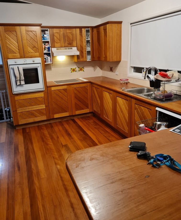 Wooden kitchen with matching cabinets, countertops, and hardwood floor. Built-in oven and range — AMAC Painting & Maintenance Nowra In Nowra, NSW