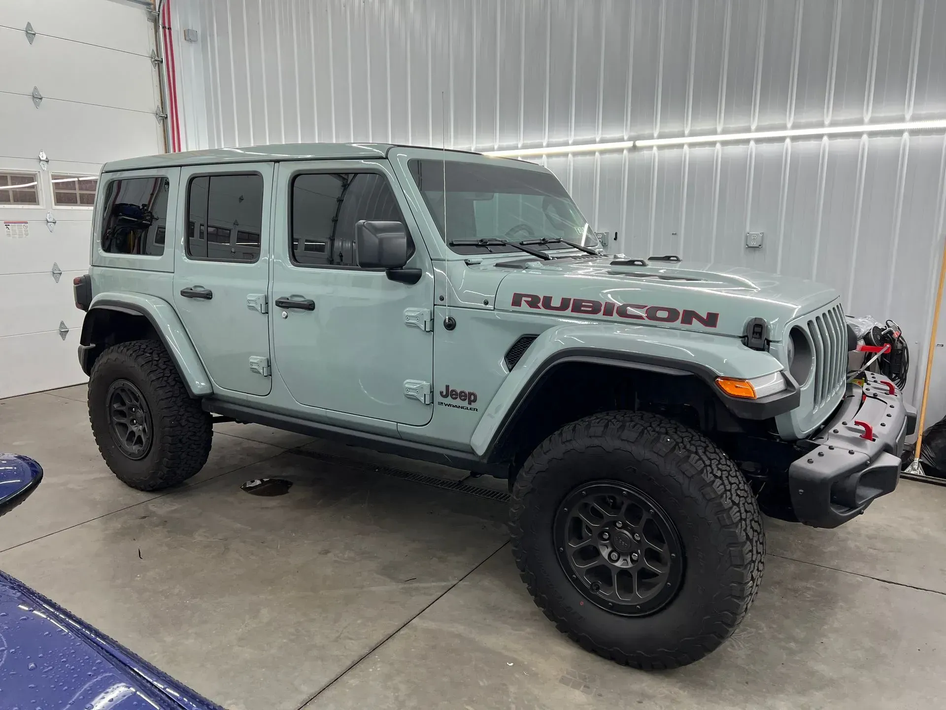 A jeep wrangler rubicon is parked in a garage.
