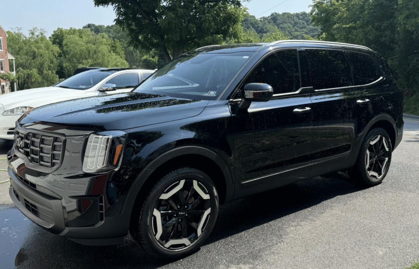 A porsche 911 is covered in foam at a car wash.