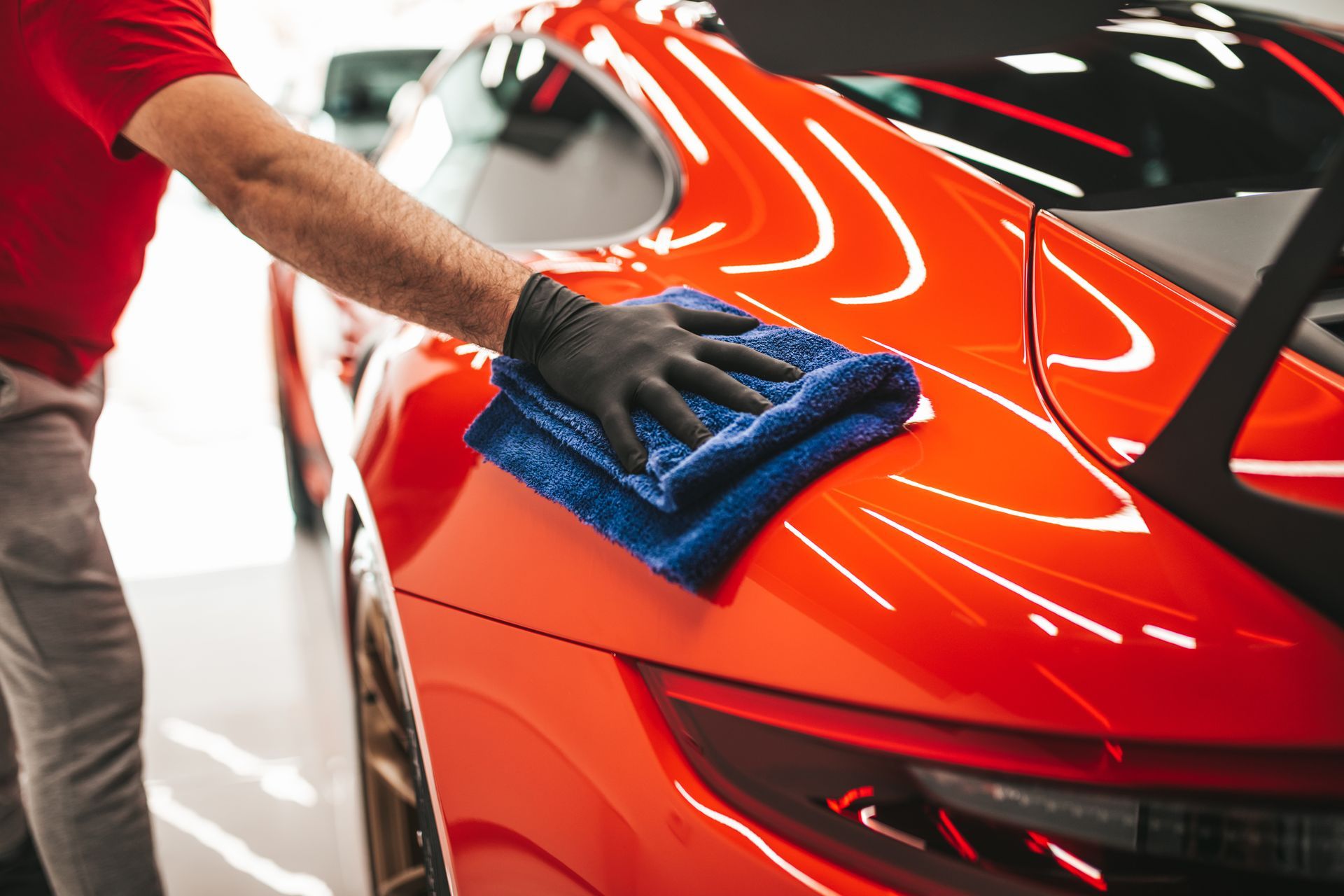 A person is washing a car with foam.