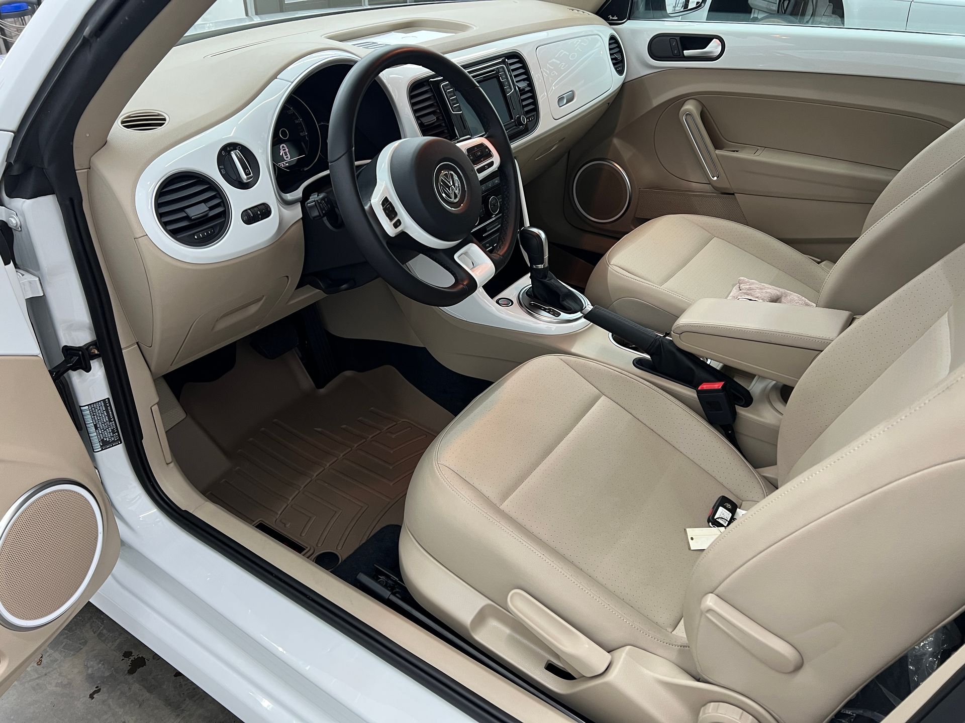 The interior of a white car with tan leather seats