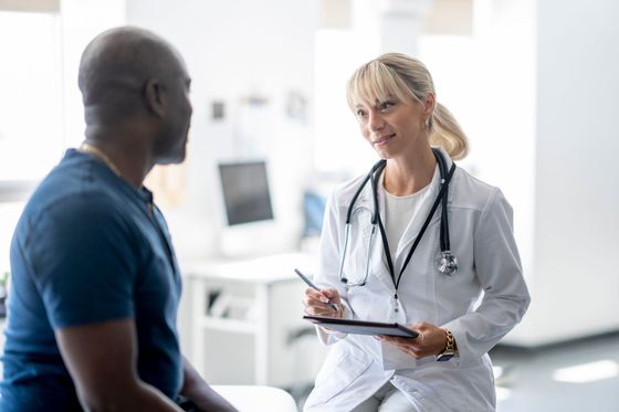 A woman in a white lab coat is smiling for the camera. A woman in a white lab coat is smiling for the camera.