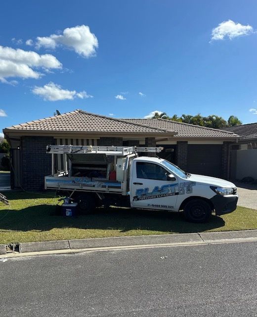 White Work Truck Parked on a Lawn in Front of a House — Blast It Pressure Cleaning - Gold Coast In Gold Coast, QLD