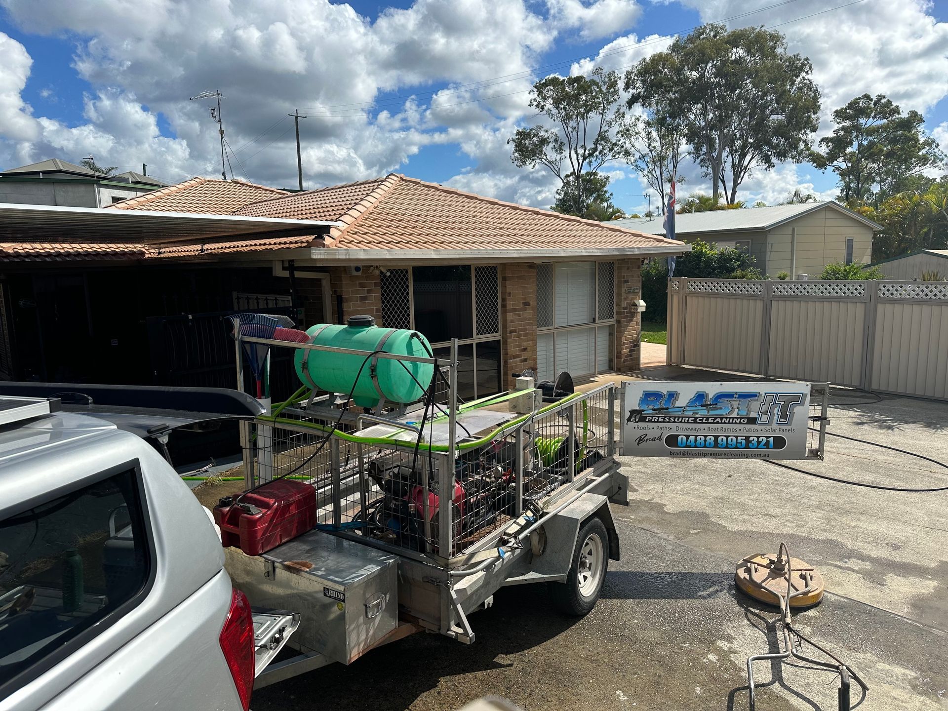 A House Being Pressure Washed; Trailer With Equipment and a Truck Parked Outside — Blast It Pressure Cleaning - Gold Coast In Gold Coast, QLD
