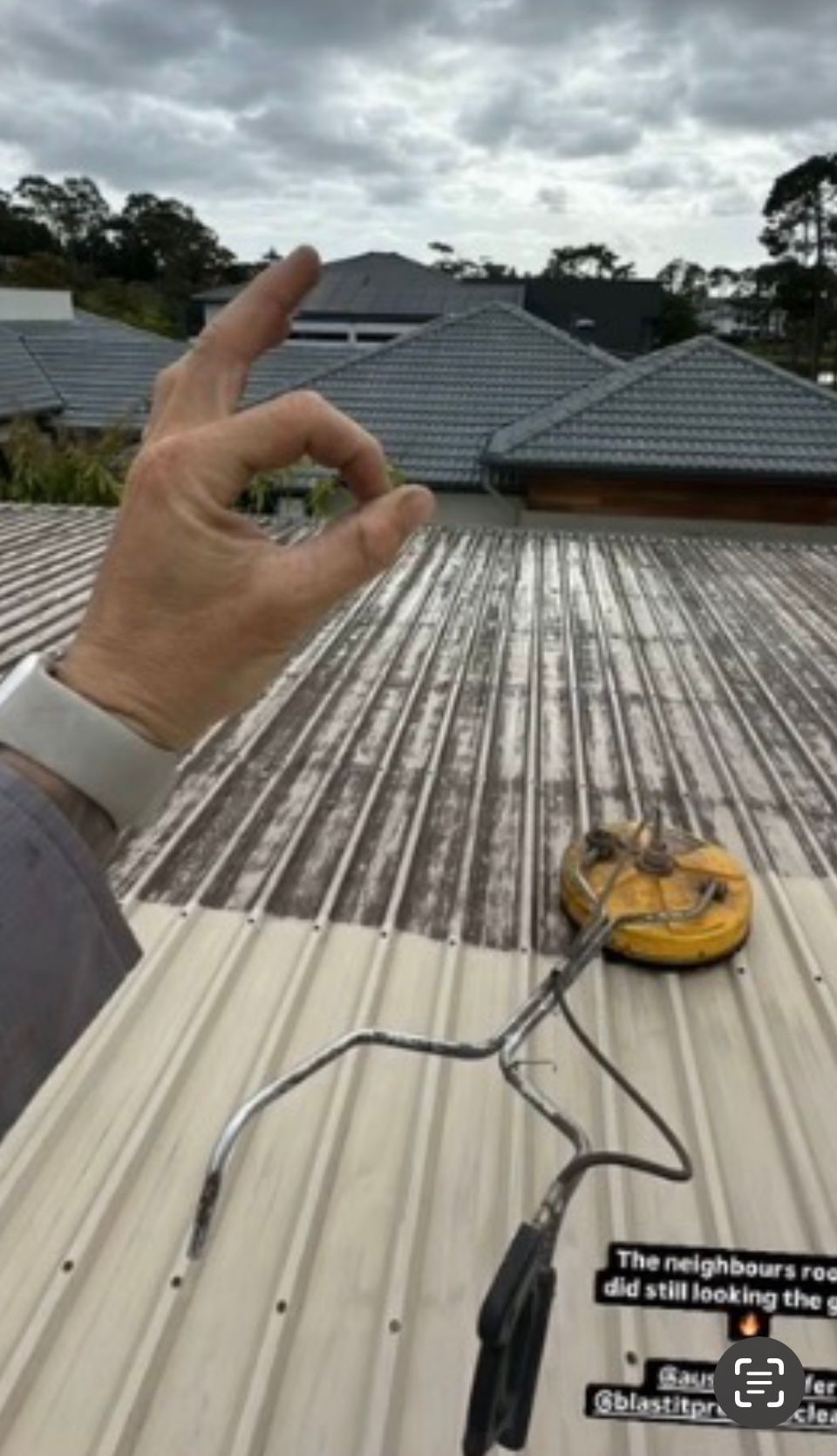 Person Cleaning a Roof With a Pressure Washer — Blast It Pressure Cleaning - Gold Coast In Gold Coast, QLD