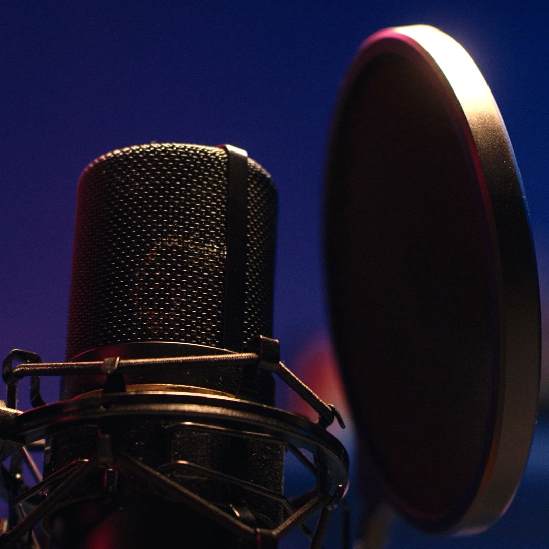 A close up of a microphone with a blue background
