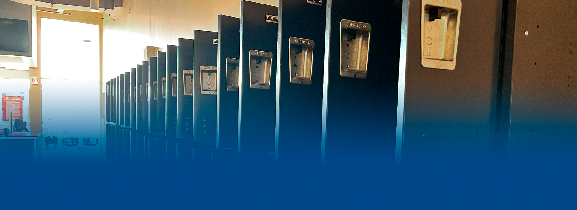 A row of black lockers in a locker room with a blue background.