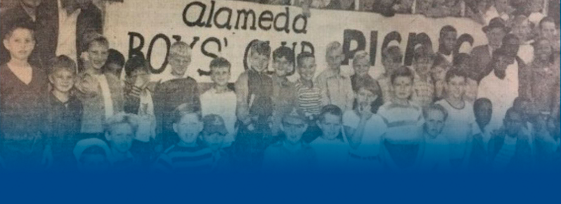 A group of children are standing in front of a sign that says alameda boys club picnic.