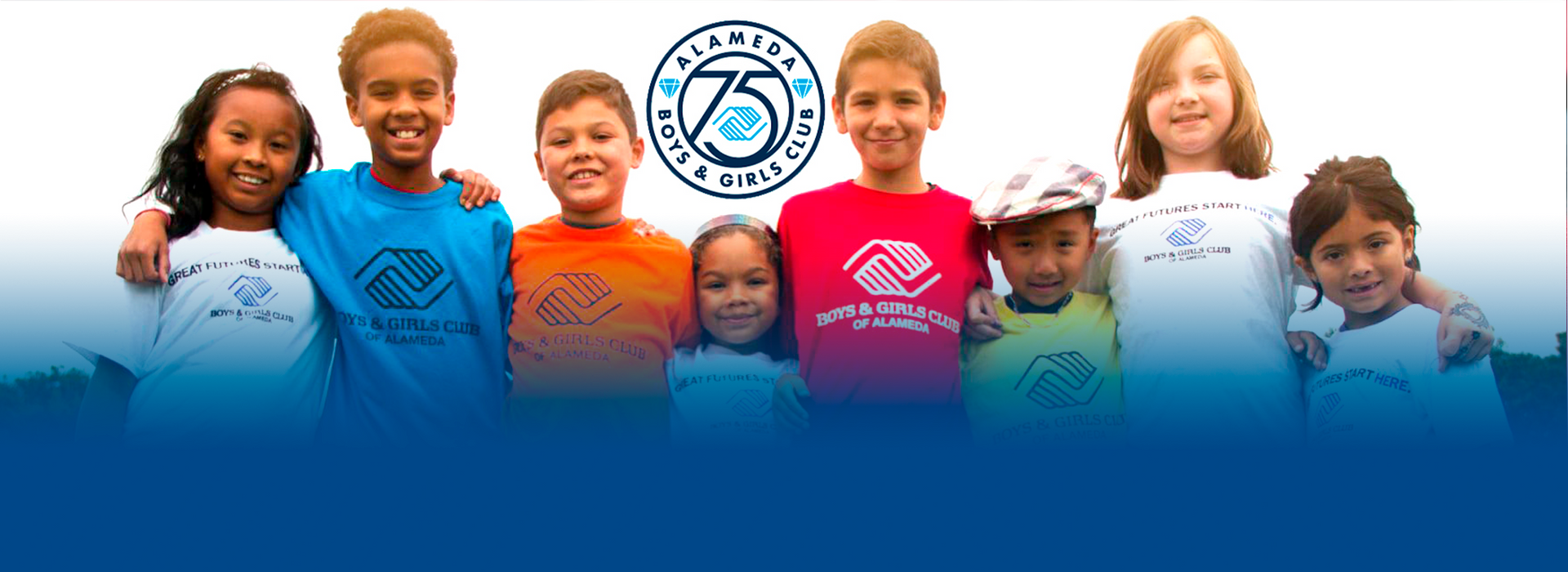 A group of children are posing for a picture in front of a 75th anniversary logo.