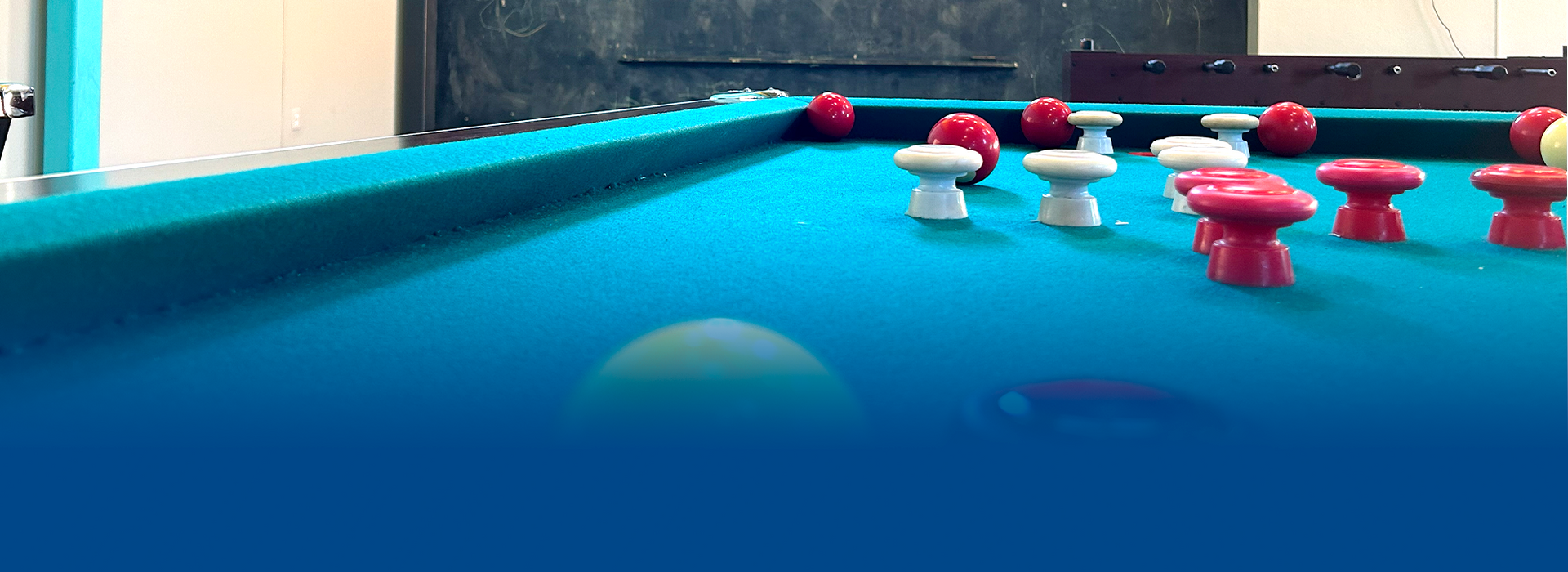 A pool table with red and white balls on it