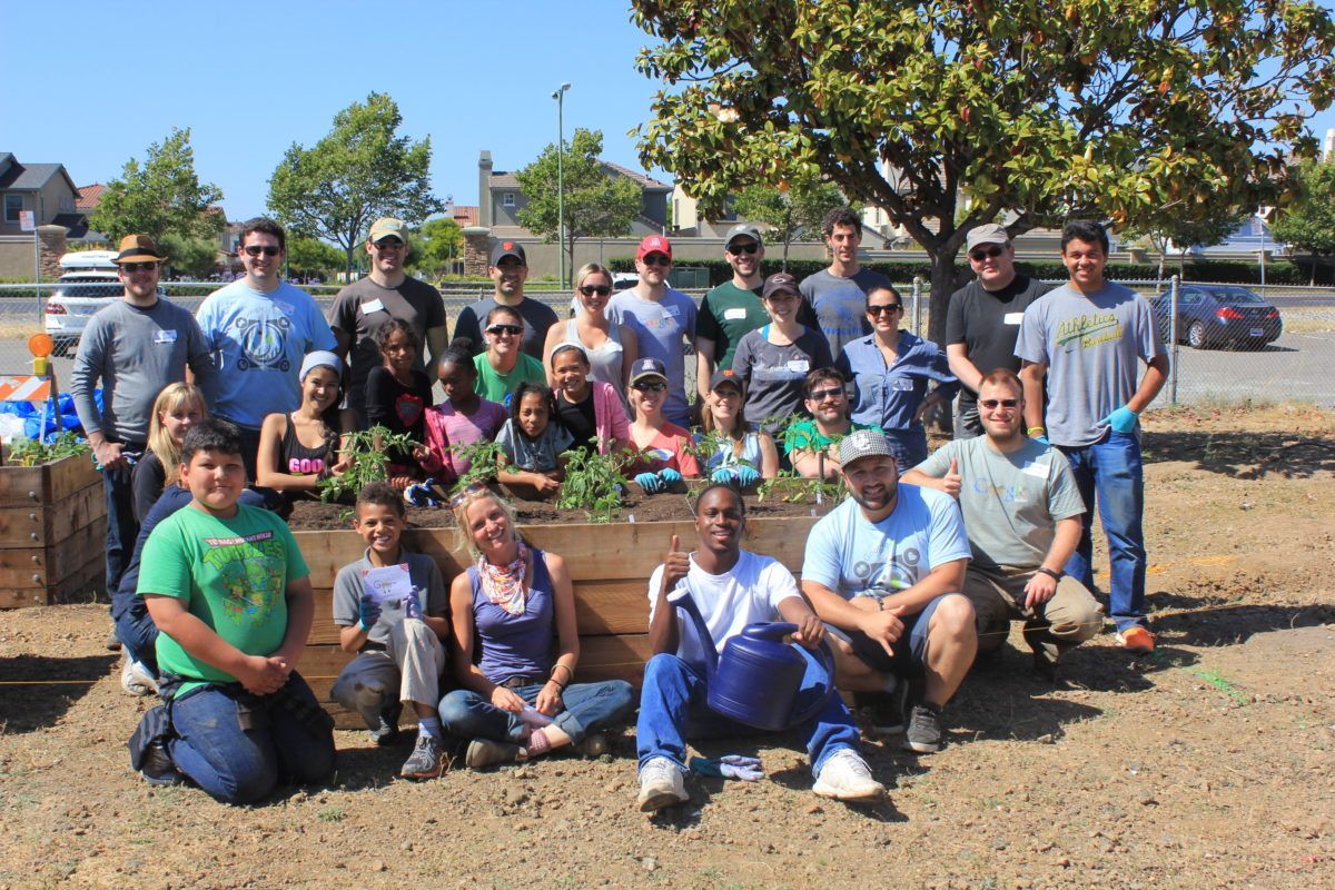 A group of people are posing for a picture in a garden.