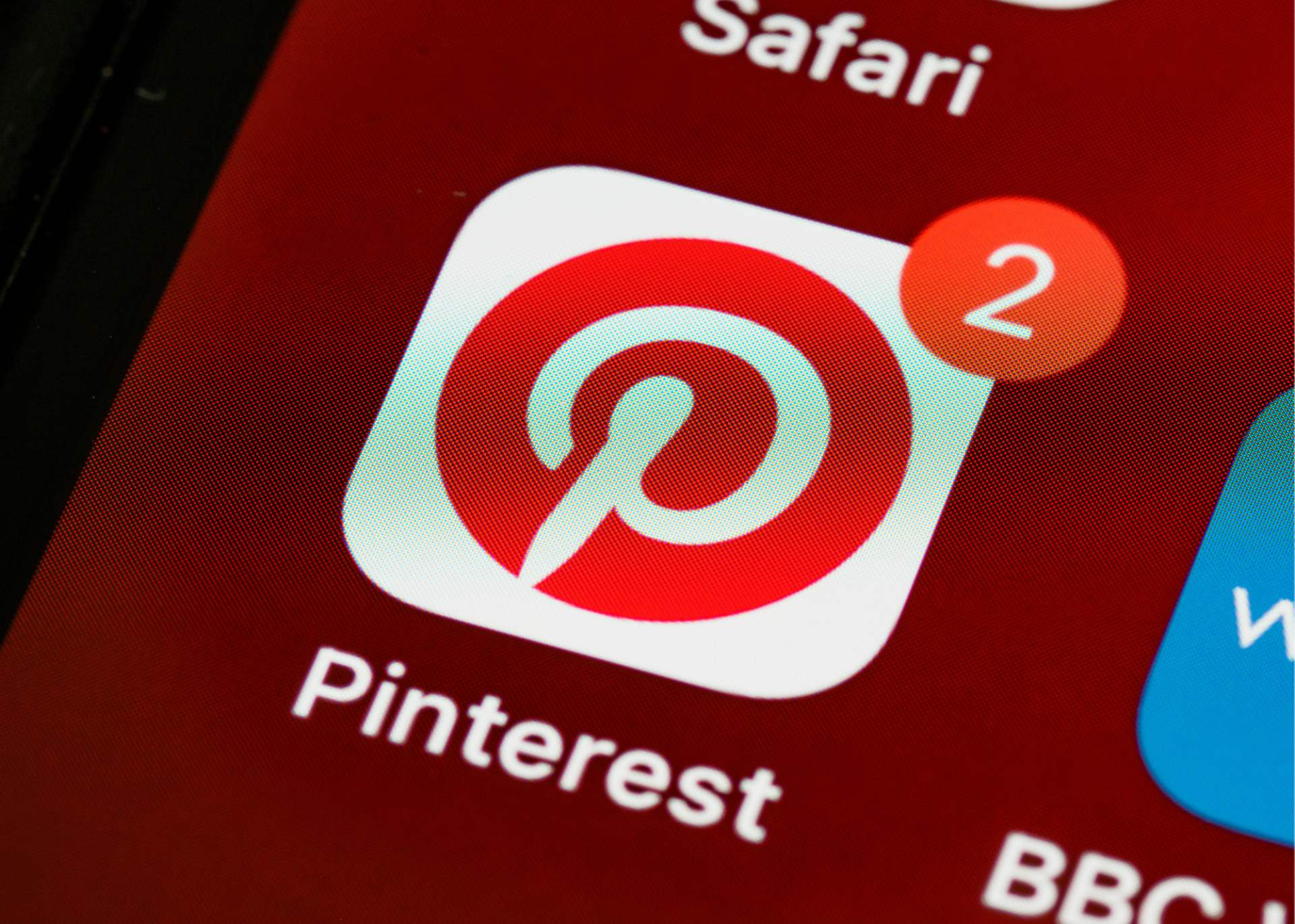 A phone screen shows the pinterest app and a safari app