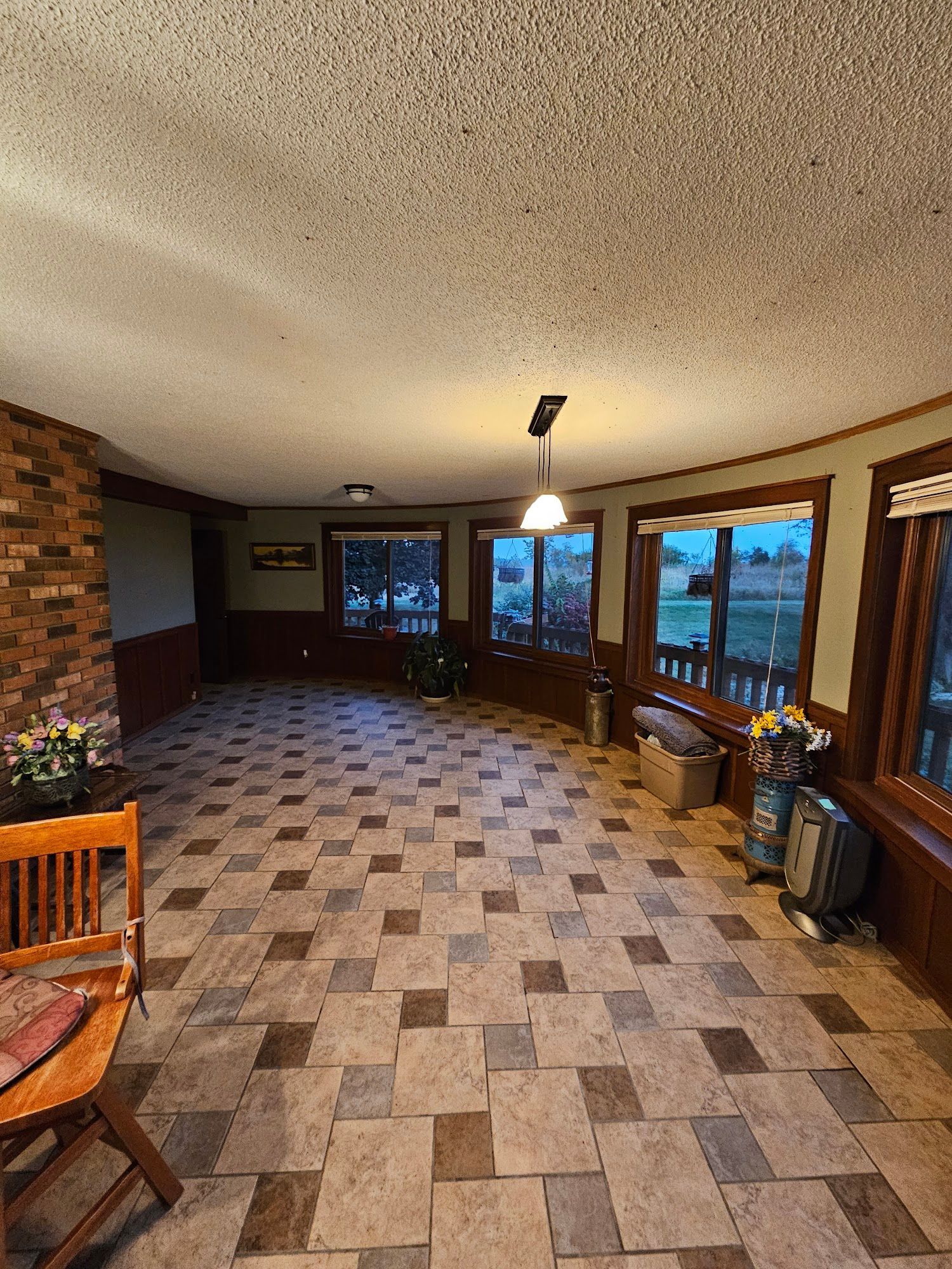 A large room with a tiled floor and a ceiling fan.