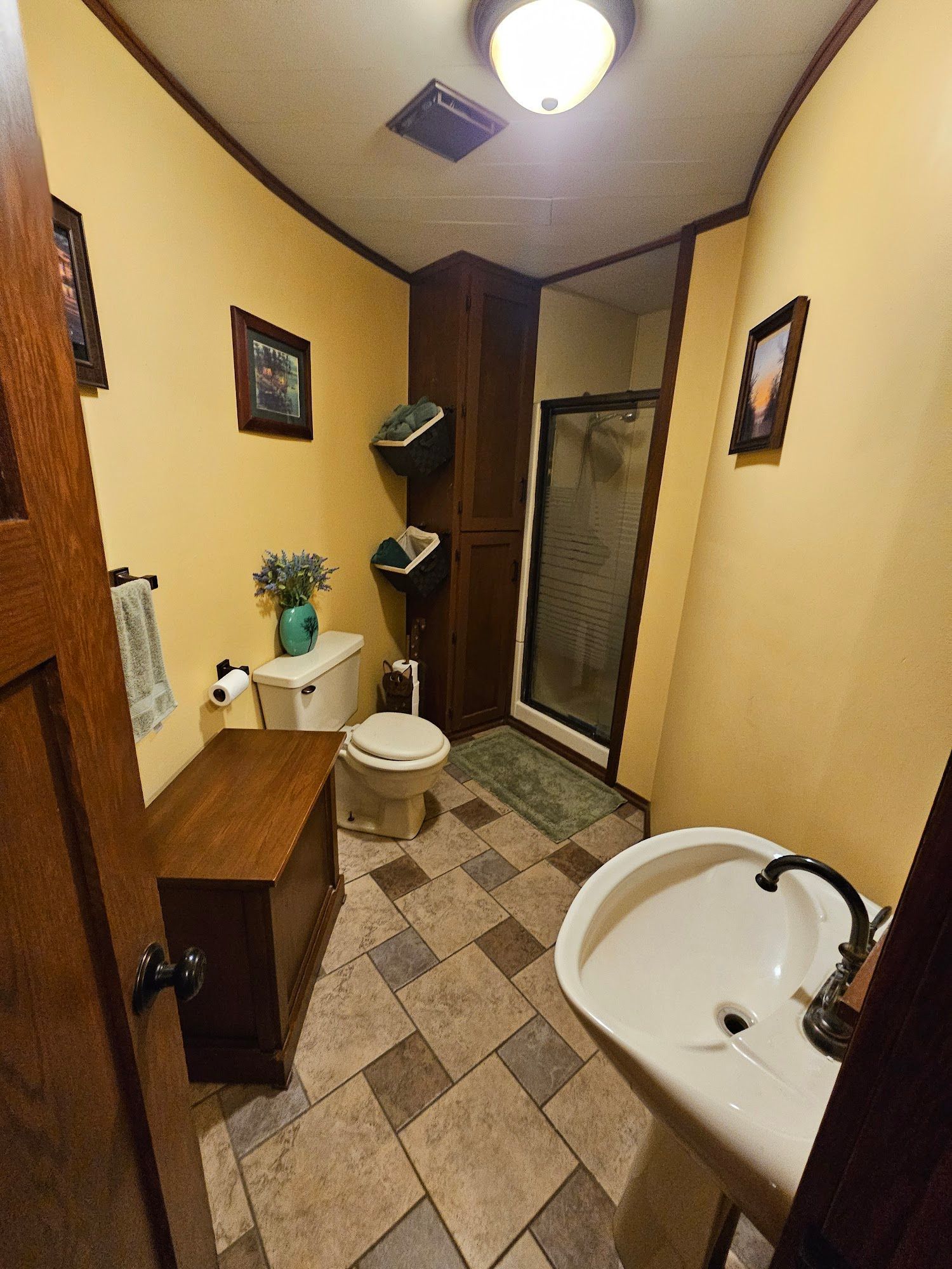A bathroom with a sink , toilet , and shower.