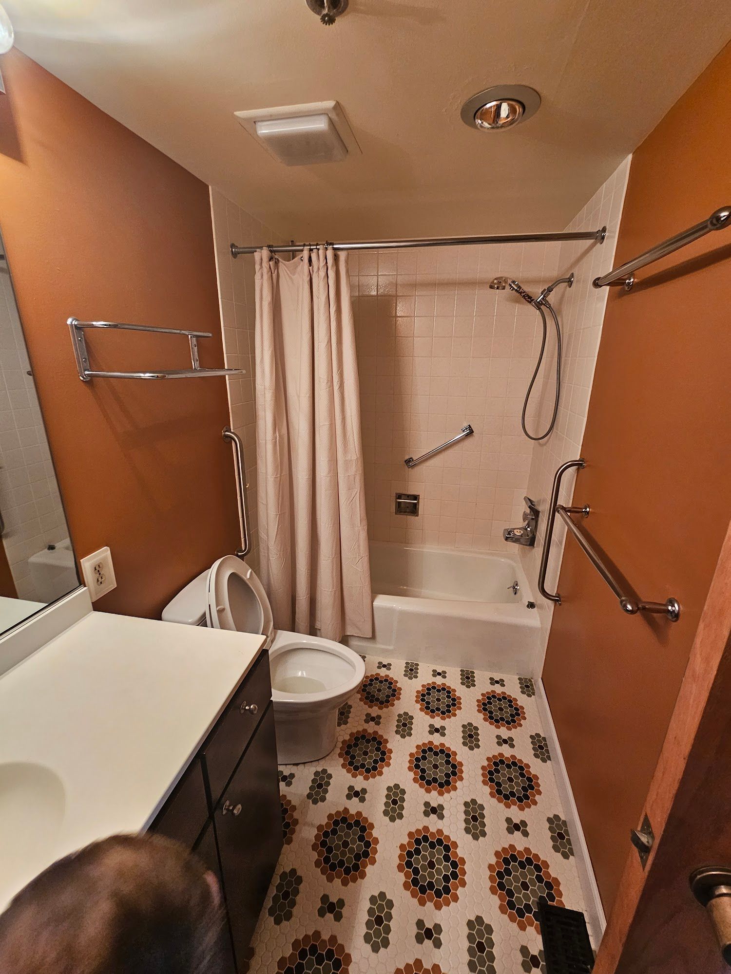 A bathroom with a toilet , sink , shower and bathtub