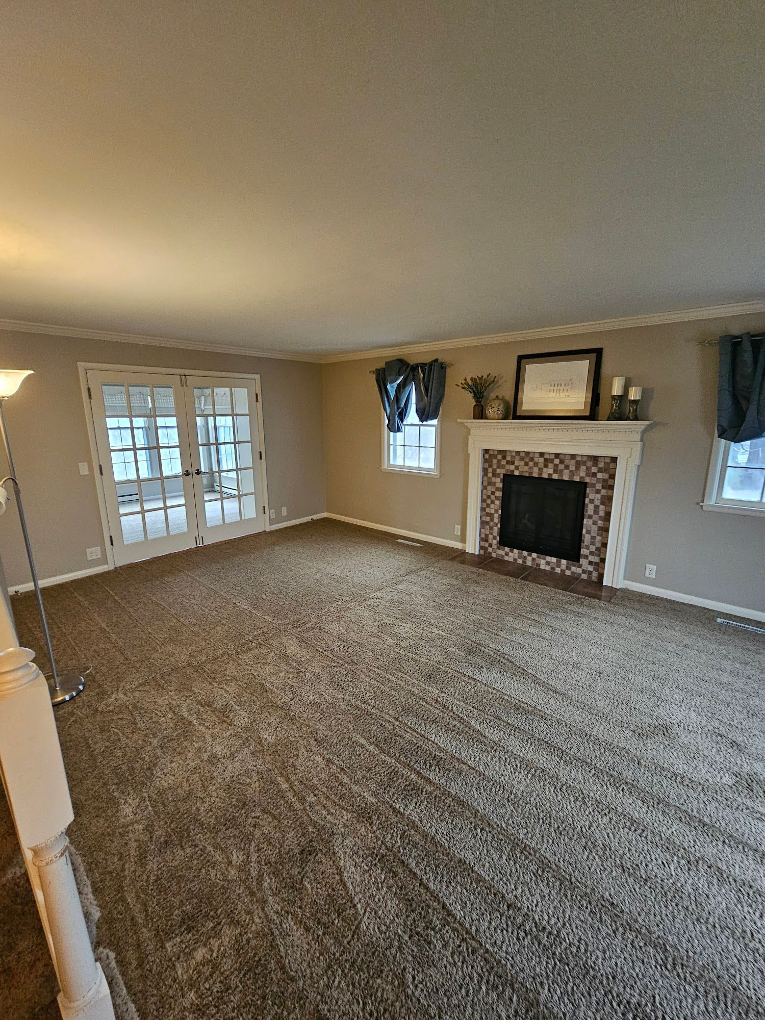 There is a fireplace in the middle of the living room.