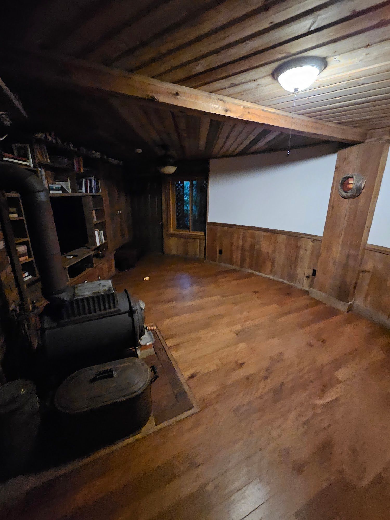 There is a wood stove in the middle of the room.