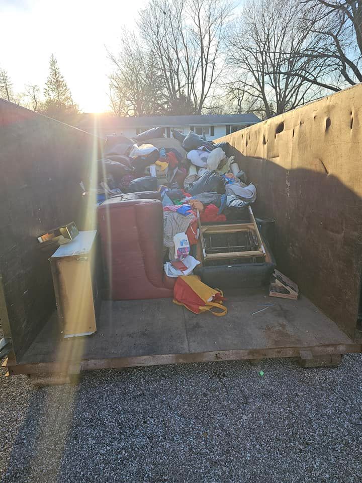 A dumpster filled with lots of trash and junk.