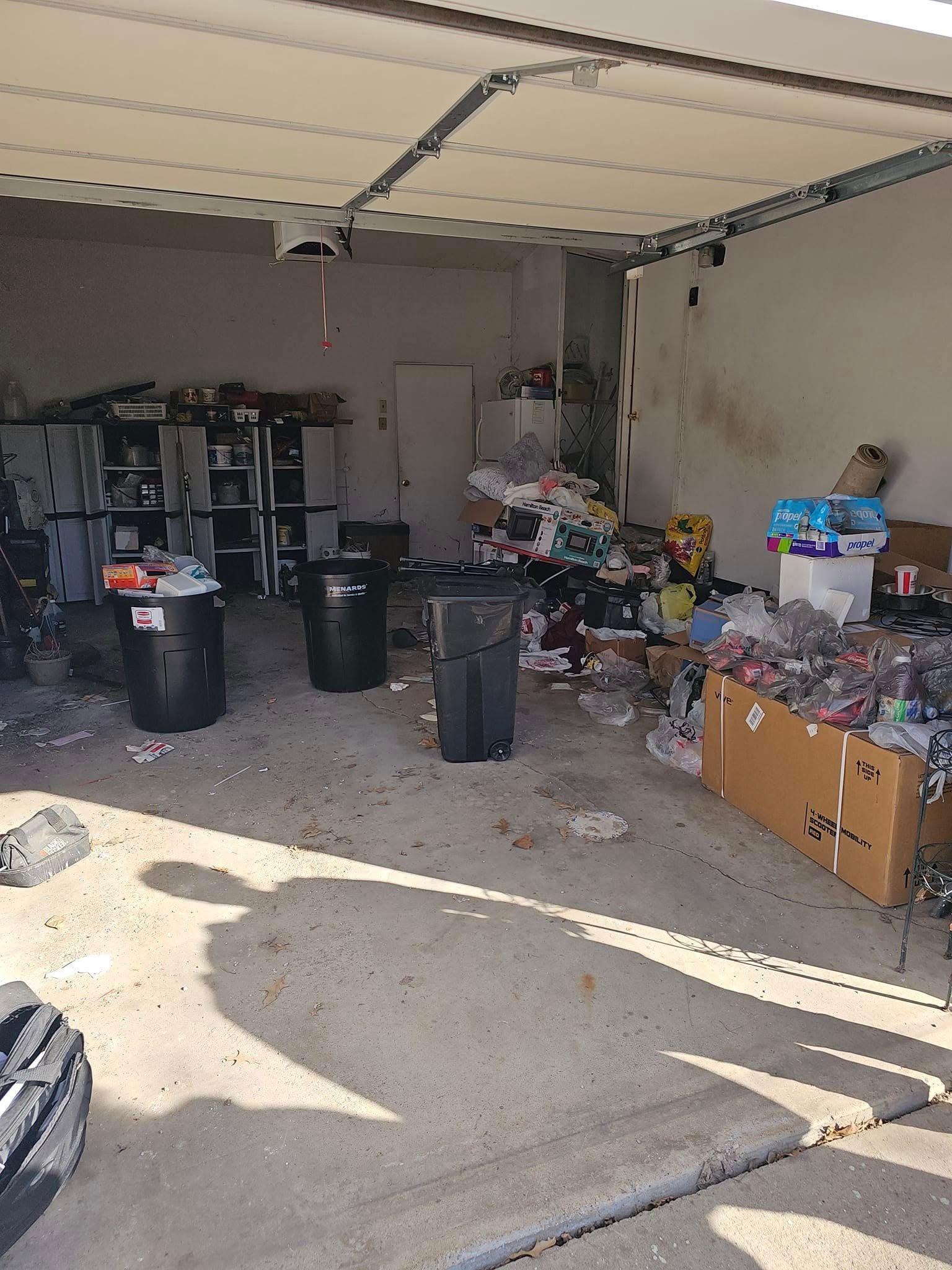 A garage filled with lots of trash and boxes.