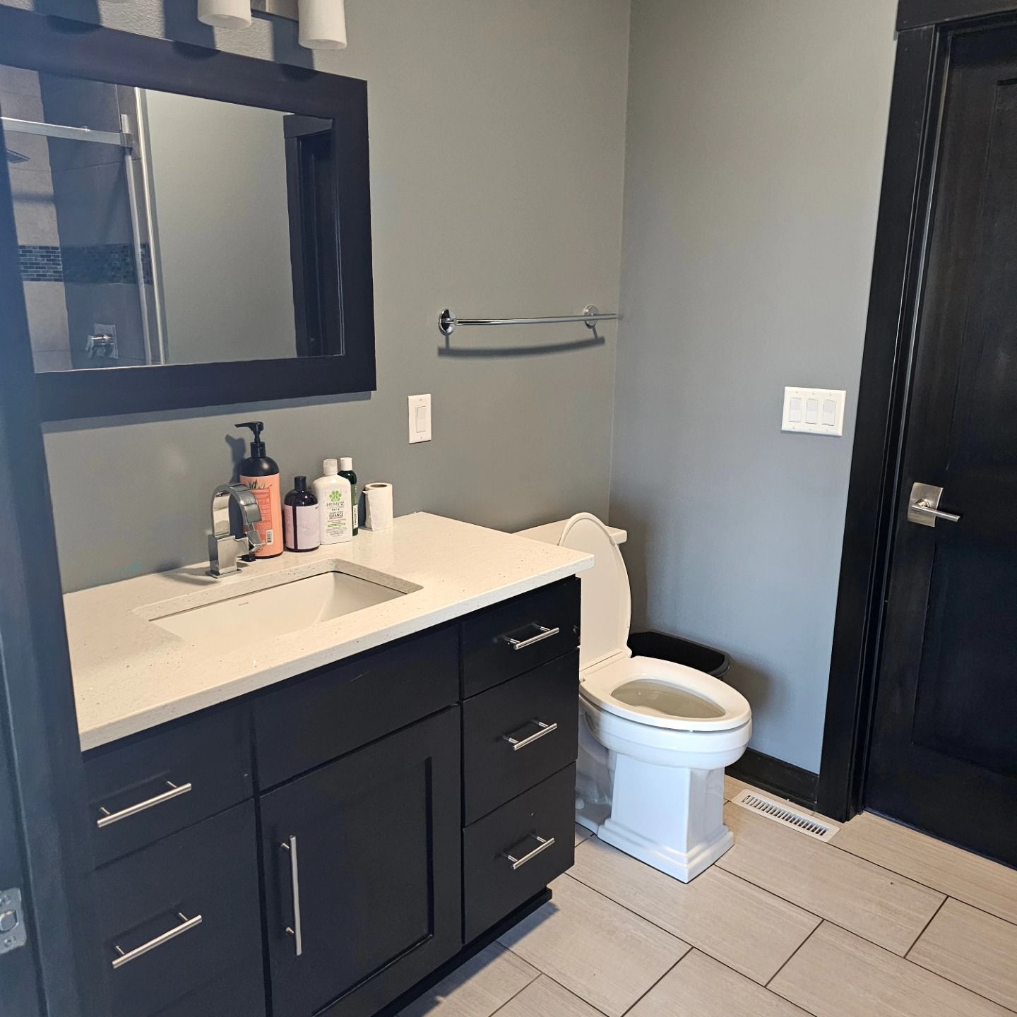 A bathroom with a sink , toilet and mirror