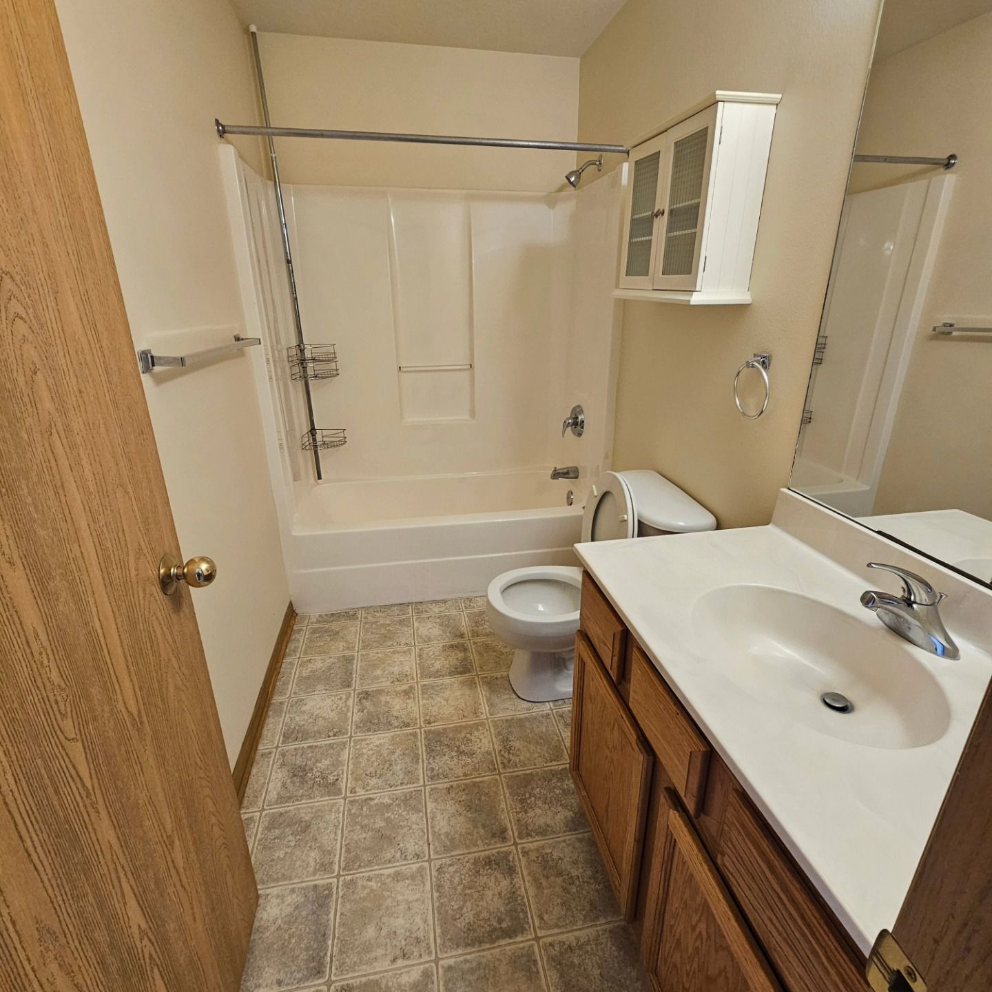 A bathroom with a sink toilet and bathtub