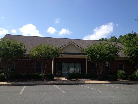 A brick building with a parking lot in front of it