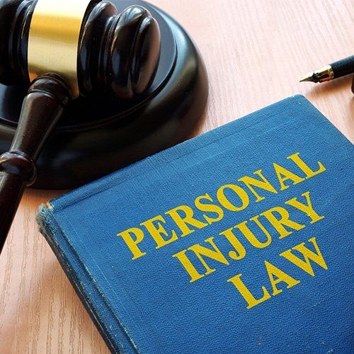 Personal Injury Law Book and Gavel on a Desk — Winter Haven, FL — Straughn & Turner, P.A.