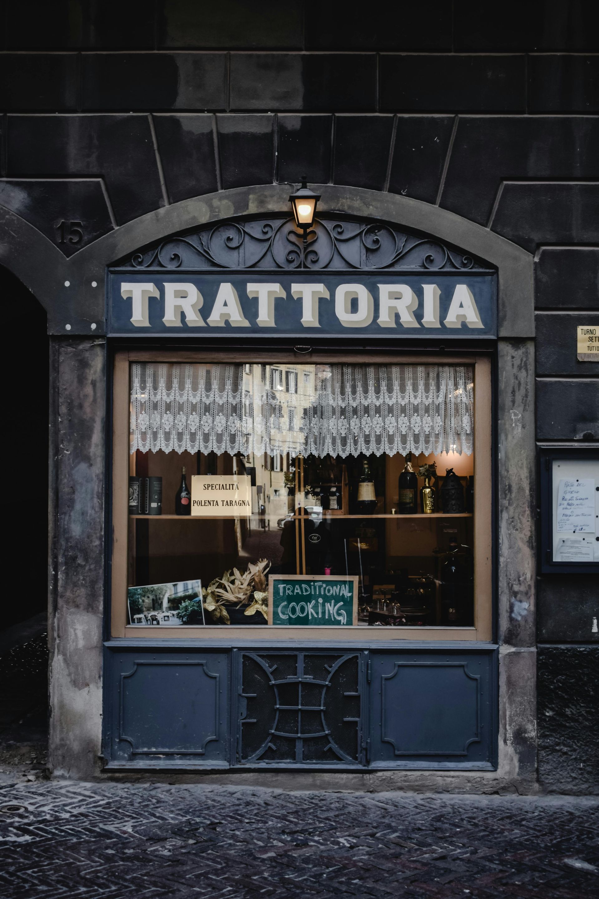 Trattoria storefront with dark blue trim,