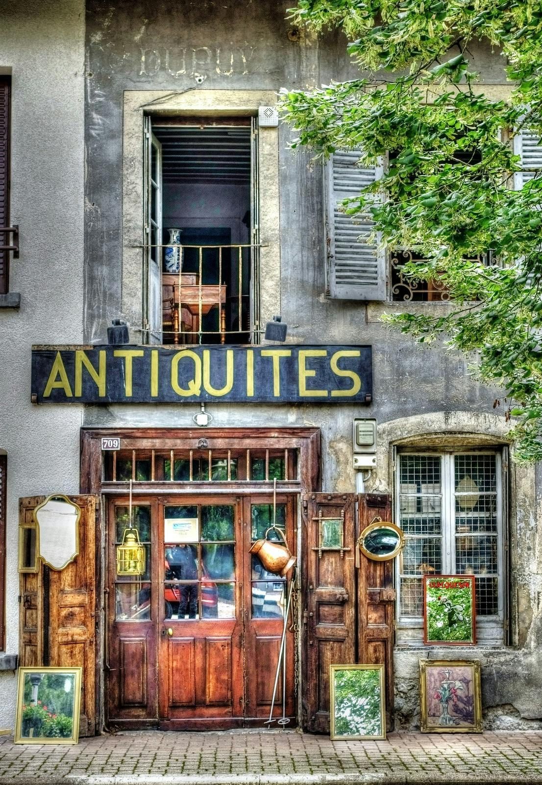 Antique shop front with wooden door, sign reading