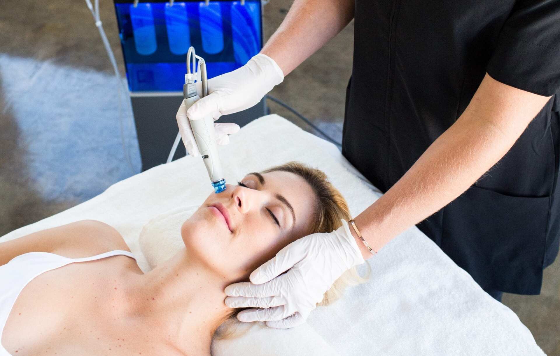 A woman is getting a facial treatment at Results Skincare Studio in Fort Myers