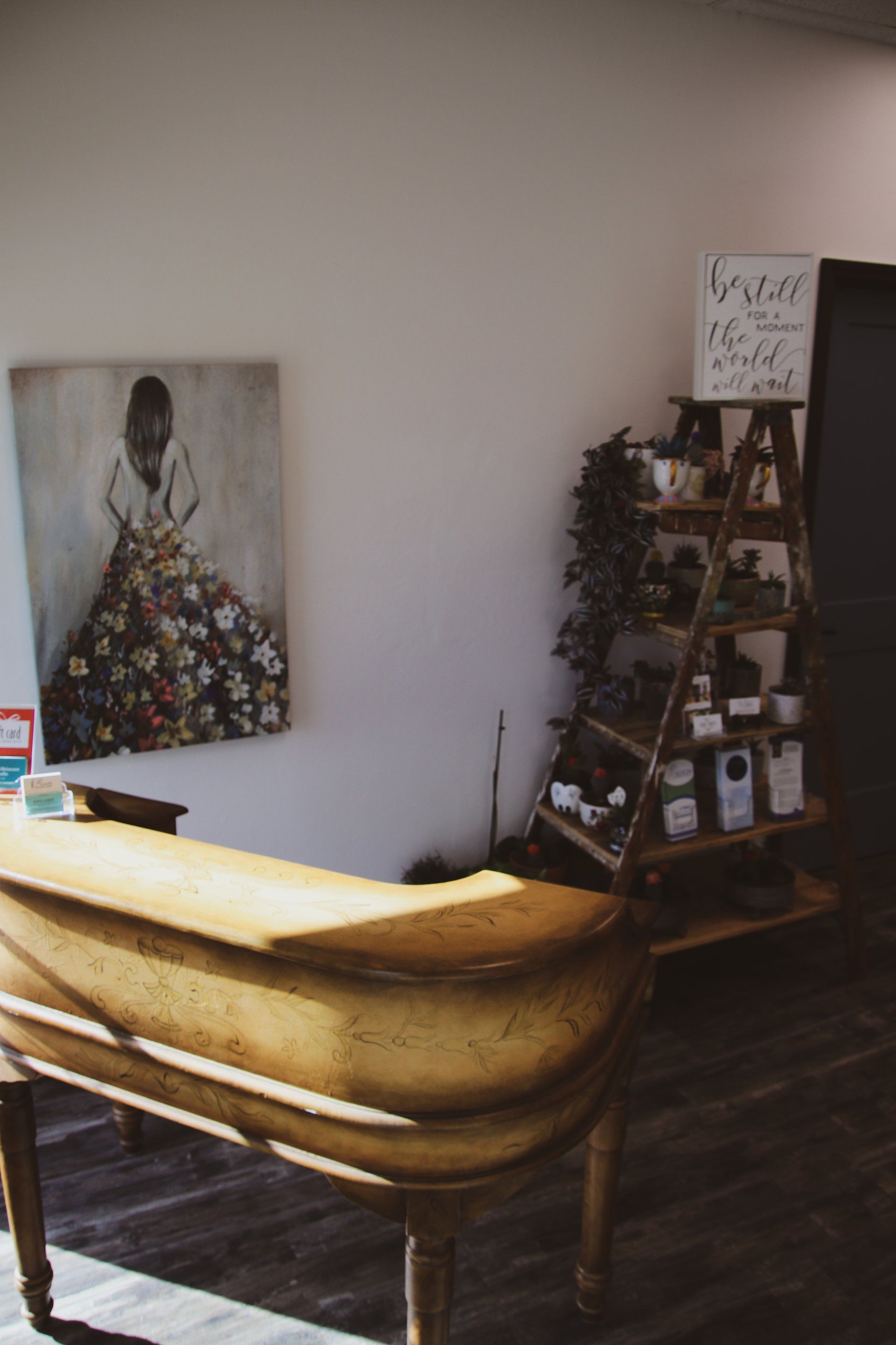 There is a painting of a woman on the wall above the counter at Results Skincare Studio in Fort Myers