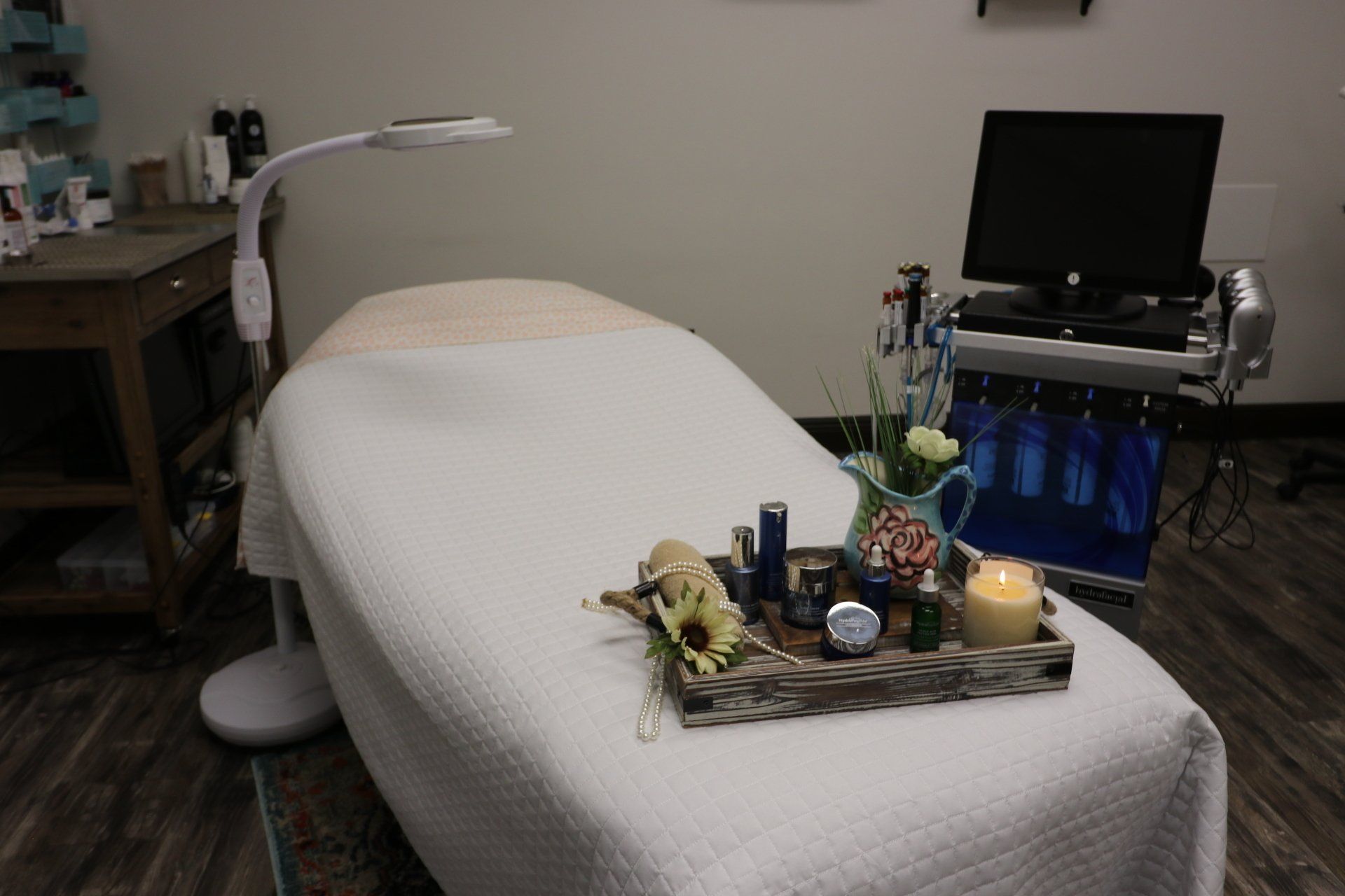 A treatment bed in Results Skincare Studio in Fort Myers with a tray of cosmetics on it