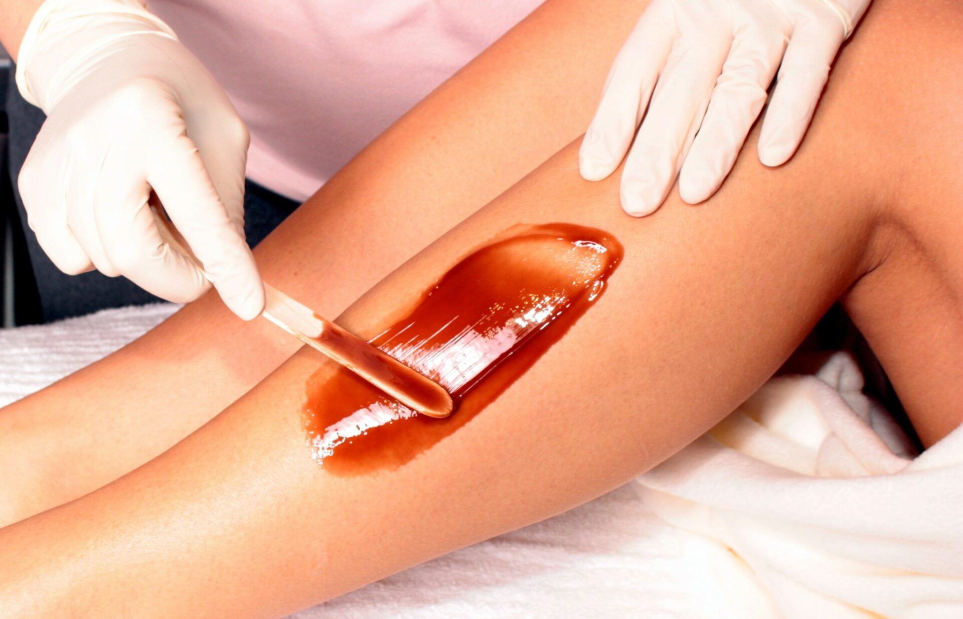 A woman 's leg is being waxed at Results Skincare Studio in Fort Myers