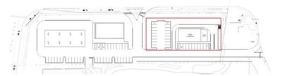 Architectural plan of a building complex, including parking areas and a highlighted section in red.