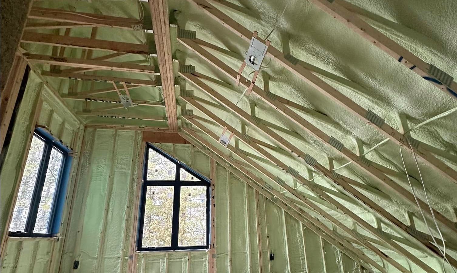 A room with a ceiling that is covered in foam and a lot of windows.